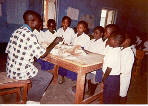 Mafuluto teacher shows his students bones of wild animals.
