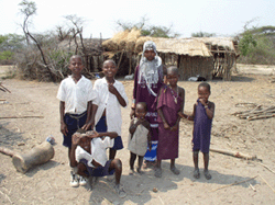 A young Maasai woman with younger siblings in Makifu Village.