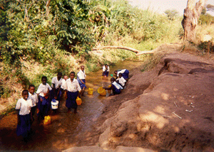 Mlowa students collecting water for their garden.